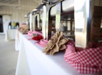 A row of food stands with red and white checkered napkins.