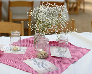 A table with jars and flowers on it