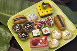 A plate of pastries and desserts on top of a table.